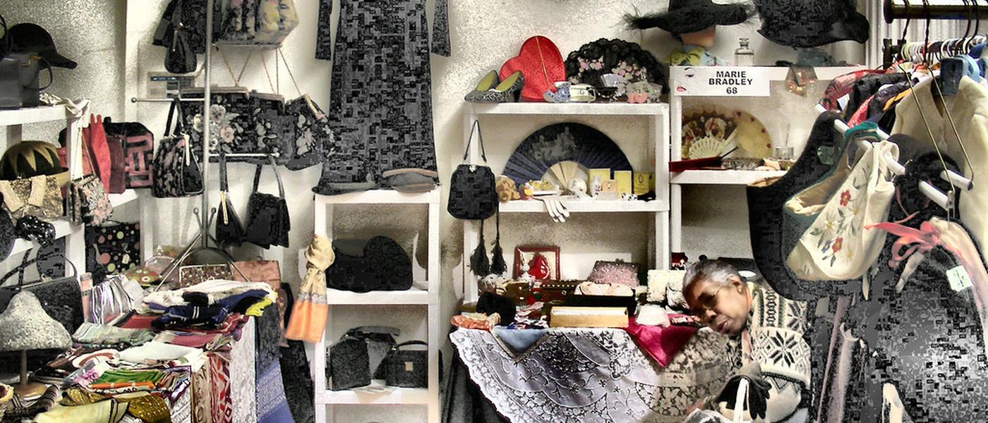 A gloriously overstuffed vintage fair stall of hats, bags and lace
