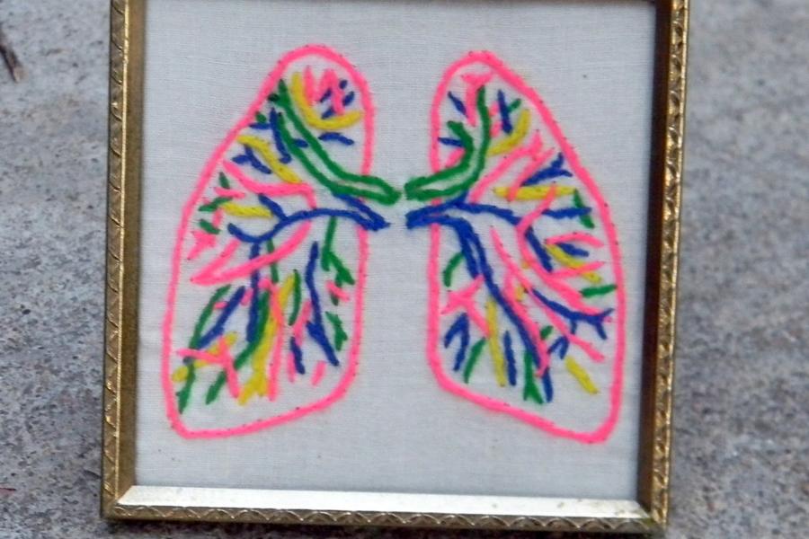 A gold-framed neon embroidery of lungs — one of our odder finds