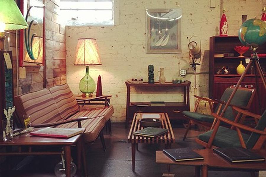 Teak sofas and lamps arranged in a mid-century furniture room