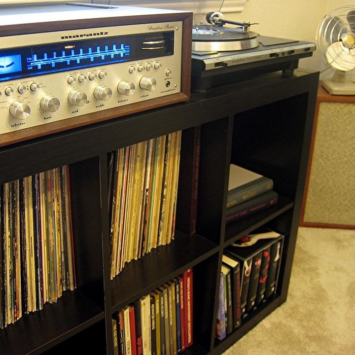 A vintage Marantz receiver on a shelf full of records
